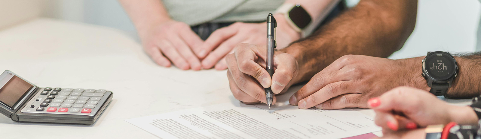 People at a table finalizing a contract